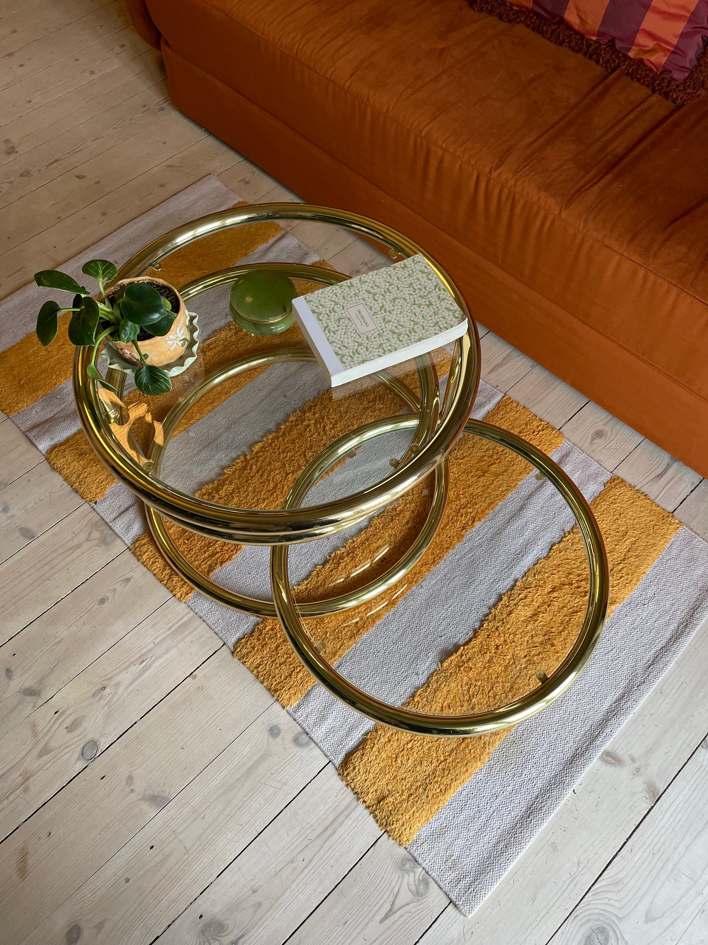 Round swivel glass table in brass