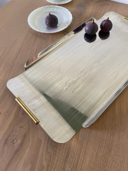 Large steel dish with gold handles and engraved details