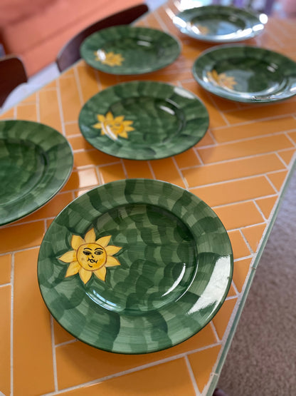 Green dinner plates with happy sun